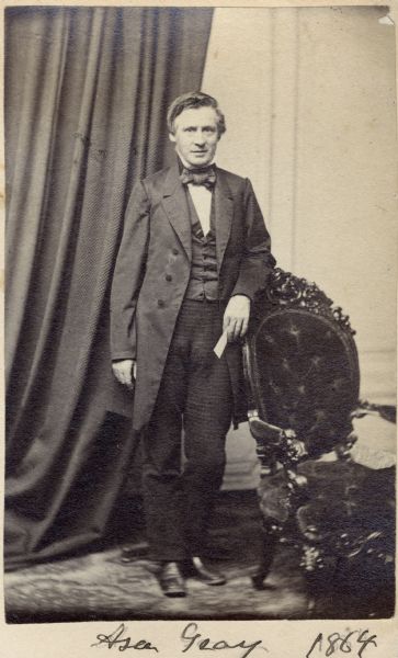 Full-length carte-de-visite portrait of Asa Gray (1810-1888), American botanist. His most popular botanical publication, "Gray's Manual," remains a standard in the field. He served as a pupil of John Torrey.  Handwritten text at bottom of image reads, "Asa Gray, 1864."