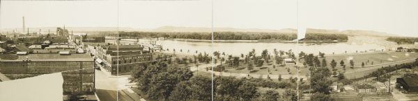 Four-panel Panoramic view of La Crosse. Indentifiable businesses in view include: J. Hogan Wholesale Grocer, T.H. Spence Drug Co., Union Refrigerator Transit Co., and H.C. Hart Implement Co. No. 2.