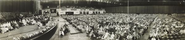 Panoramic group portrait of the biennial convention of the American Nursing Association. The nurses are in an auditorium, sitting in groups by state.