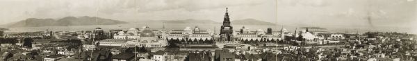 Elevated, panoramic view of the Panama-Pacific Exposition Grounds.  Numbers across bottom of image refer to a key affixed to the image.  Central building surrounded in scaffolding is the 480-foot Tower of Jewels. Alcatraz Island is visible off the shore.