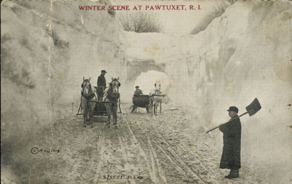 Two horse-drawn carriages travelling through a snow-covered enclosure.  A man stands off to the side, holding a snow shovel. Red text in the upper portion reads, "Winter Scene at Pawtuxet, R.I."