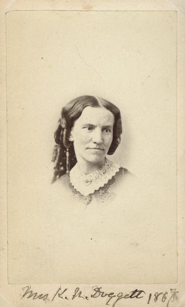 Vignetted carte-de-visite portrait of Kate N. Doggett (1828-1884), American reformer. Took charge of the Academy of Science herbarium in 1869. She was a delegate of the National Women Suffrage Association.  She also founded several French and German societies and Fortnightly, a literary society. Handwritten inscription at the bottom reads, "Mrs. K.N. Doggett, 1867."