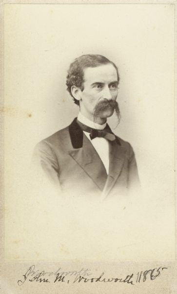 Vignetted carte-de-visite portrait of Dr. John Maynard Woodworth (1837-1879), American physician and naturalist. In 1871, Woodworth became the first Surgeon General of the United States. He was one of the organizers of the Chicago Academy of Science and in 1858 became curator of its museum. Woodworth served under General William Tecumseh Sherman as a surgeon in the Civil War, and lead the ambulence train during "Sherman's March," without losing a single man. Shown in a Russian-American fur trapper's costume. Handwritten inscription at bottom of card reads: "John M. Woodworth, 1865."