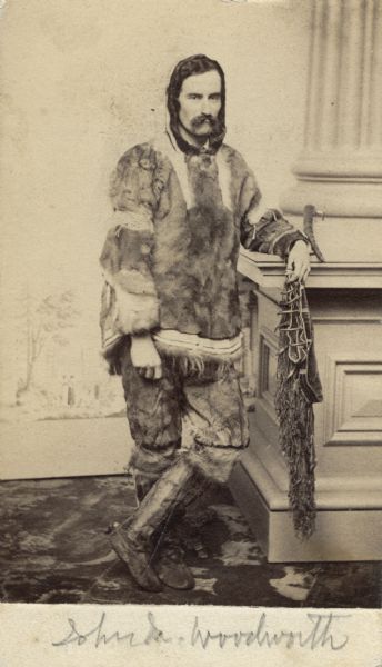 Carte-de-visite portrait of Dr. John Maynard Woodworth (1837-1879), an American physician and naturalist who is shown in a Russian-American fur trapper's costume. Handwritten inscription at bottom of card reads, "John M. Woodworth."
