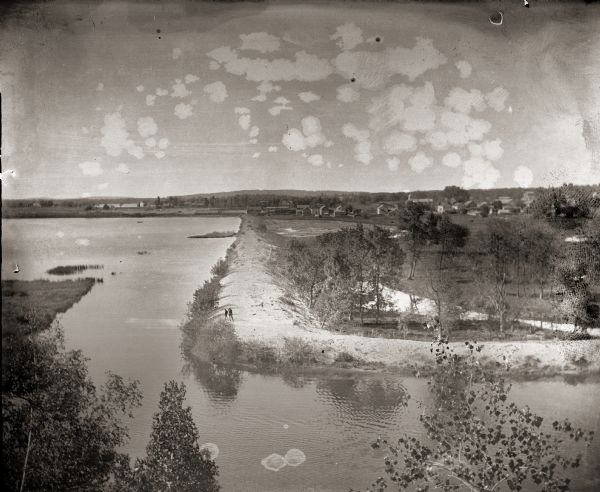 A view from the bluff of group of men on the dredge bank of Buffalo Lake.