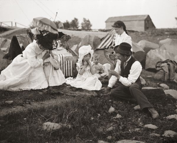 Family group resting on Court House hill, near Perkin's cottage.