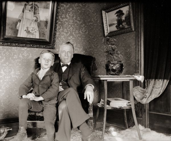 Cary Bass and his Great Uncle Cary seated in a chair. They are most likely inside the Bass family home at 207 Clay Street.