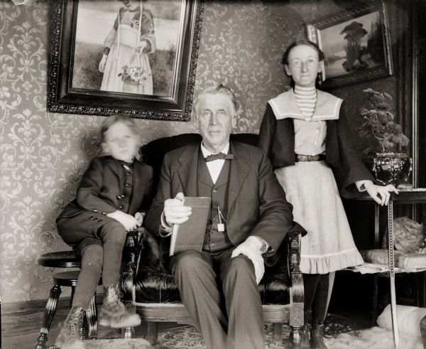 Great Uncle Cary posing with Everetta and Cary Bass. They are most likely seated inside the Bass family home, 207 Clay Street.