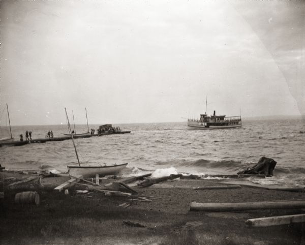 Steamboat approaching pier on unidentified lake.