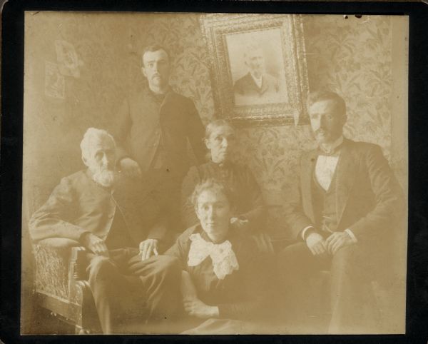 A group portrait including Dr. Edward A. Bass, seated on the far right, next to his parents, Isaac W. and Lorinda Hill Bass.   Dr. Bass's brother Frank Bass stands behind their parents; sister Rhoda Bass is seated on the floor.