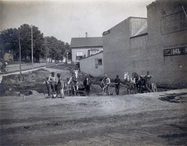 Workmen with teams of horses excavate for the new Mercantile Store, later the M.M. Smart Store.