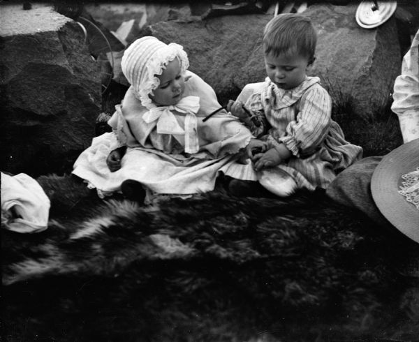 The photographer's son Edward Cary Bass (right) on his first birthday, with Lois. They are sitting on a fur blanket among rocks. Taken at a picnic on Court House Hill.