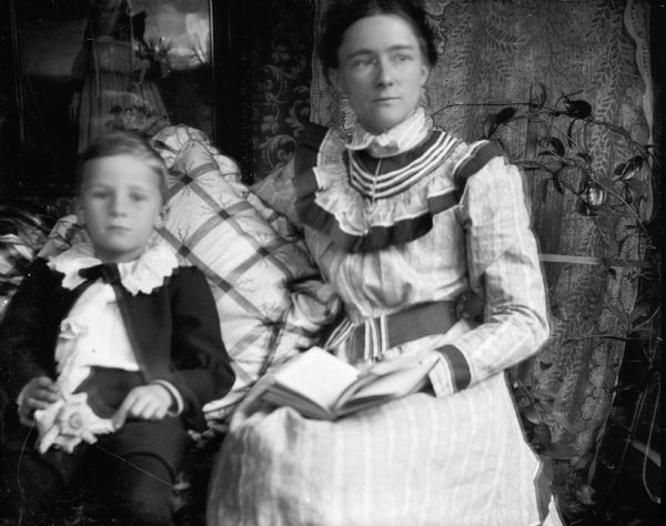 Ada Bass with her son, Edward Cary, sitting on a couch.