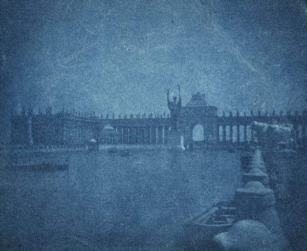A cyanotype view of the central basin, Peristyle and Statue of the Republic.  There are several boats on the basin.  On the right is a large statue of a bull.