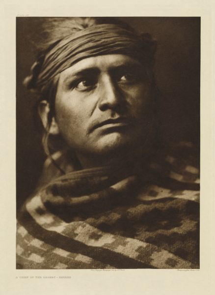 The original caption reads: "Picturing not only the individual but a characteristic member of the tribe — disdainful, energetic, self-reliant." A head and shoulders portrait of a Navajo man.