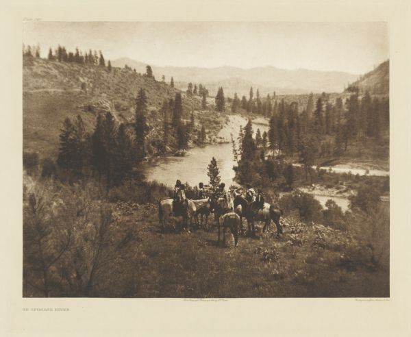 The original caption reads: "Spokane river, from a short distance below its head in Coeur d'Alene lake to its confluence with the Columbia, flows through the midst of what was the territory of the Spokan Indians. The character of the country through which the stream passes for some miles above its mouth is well shown in the picture. Northward from the stream lie the mountains among which the three Spokan tribes hunted deer and gathered their supplies of roots."