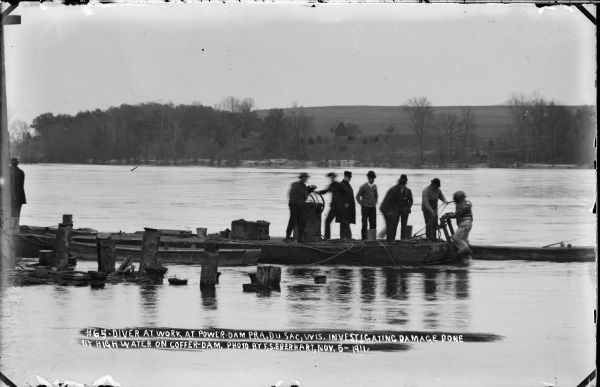 A diver and team working to inspect the coffer dam for underwater damage caused by flooding.