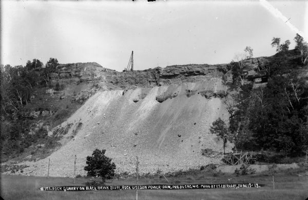 A view, from the west, of the quarry on Blackhawk Bluff. Gravel from the quarry was used in concrete for the construction of the power plant and dam.