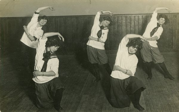 Five young women in a dance-like pose for a gymnastics class in one of Milwaukee's Social Centers.