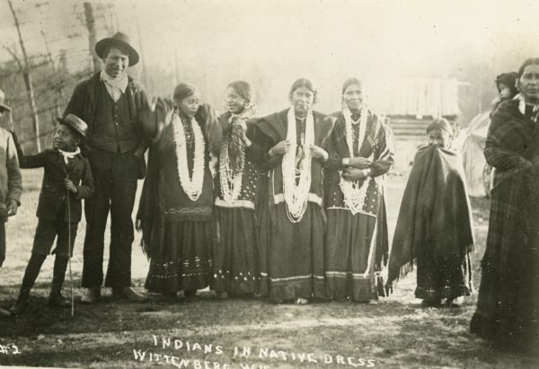 Group of Winnebago (Ho-Chunk) Indians in traditional dress. Caption reads: "Indians in Native Dress, Wittenberg, Wis."