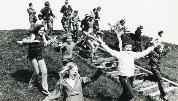 Fifth-graders from Mayville Public School celebrate the end of the school year by running down the earthen mounds at Aztalan State Park. Teachers on the trip were Joe Hetzel, Mr. Harmon, Arnold Muche and Mrs. Day.