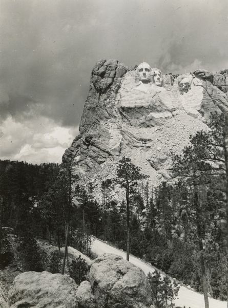 Construction on Mount Rushmore. Scaffolding is visible across Abraham Lincoln's face. Work has just begun on Theodore Roosevelt.