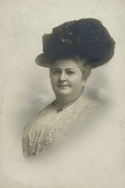 Vignetted studio portrait of Mrs. Simon Kander, author of <i>The Settlement Cook Book</i>, wearing a hat.