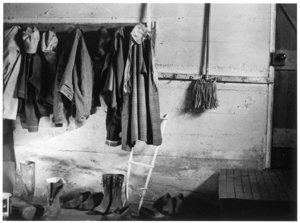 The Quinney farm basement with clothes and shoes against the wall.