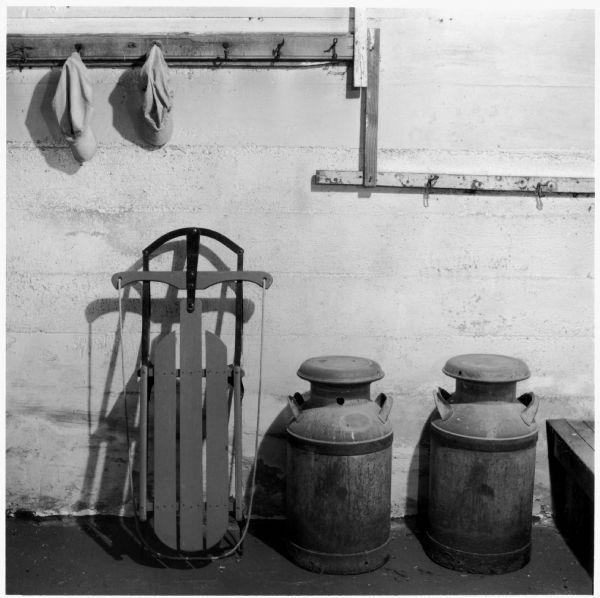 Work caps, sled, and milk cans in the basement of the Quinney farmhouse.