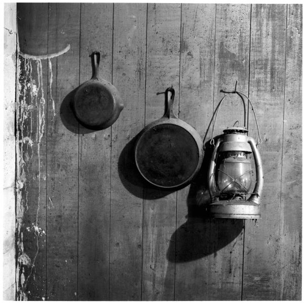 Skillets and lantern hanging on the wall in the Quinney farmhouse.