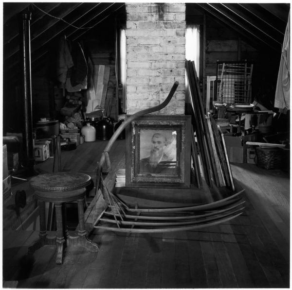 The attic of the Quinney farmhouse. A photograph (crayon portrait) of the photographer's great-grandfather, Nathan Church Reynolds (1828 - 1895) is leaning against the chimney.
