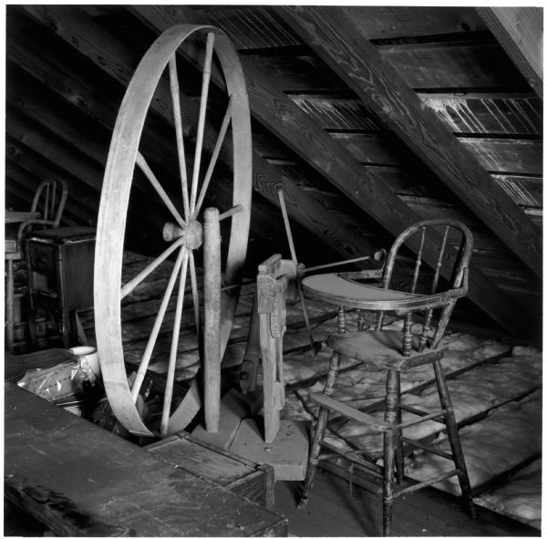 Spinning wheel and high chair in the attic of the Quinney farmhouse.