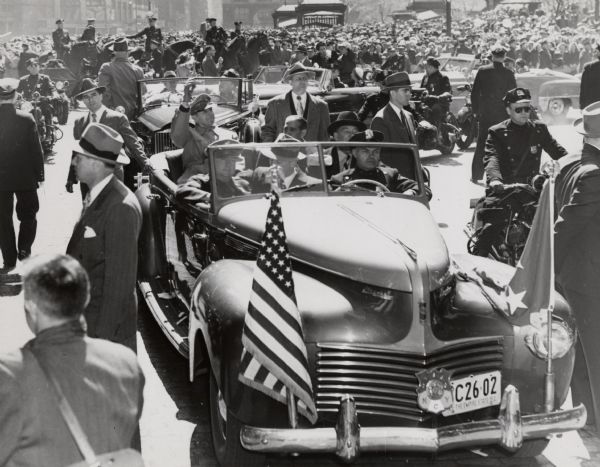General Douglas MacArthur rides in an open car during the ticker tape parade in his honor. MacArthur had just returned to the United States, having been relieved of his command in Korea by President Harry Truman.
