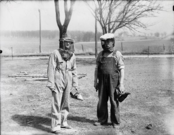 The state bee inspector (probably the man on the left), and a Dane County farmer.