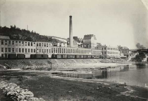 The Menominee River and paper mill as photographed by William A. Hotchkiss for the Wisconsin Good Roads Association.