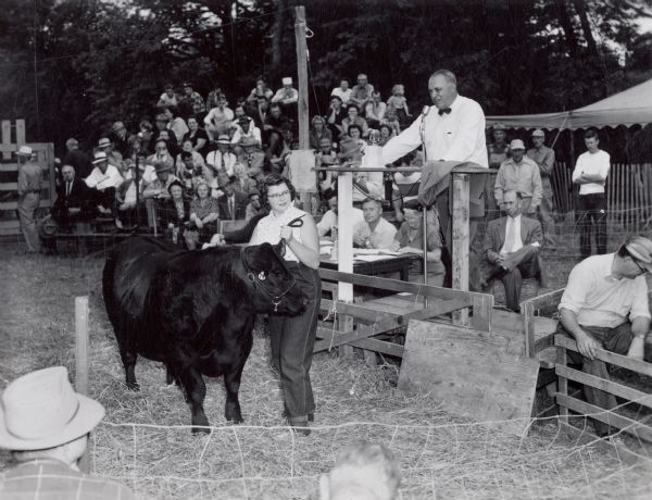 A young woman shows her entry in the Central Wisconsin Junior Livestock Competition.