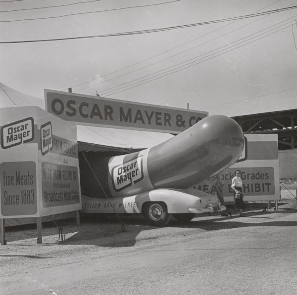 The driver of the wienermobile finds the entrance to the Oscar Mayer tent at the Wisconsin State Fair too low for it to get in.