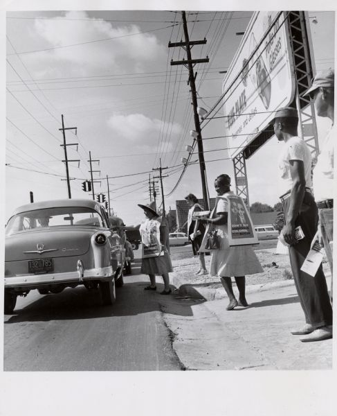 Striking members of the United Packinghouse Workers employed by the Colonial Sugar Company in New Orleans, Louisiana, distribute literature to passers-by urging a product boycott.  This picture is important because at the time few international unions were attempting to organize a multi-racial workforce in the South.