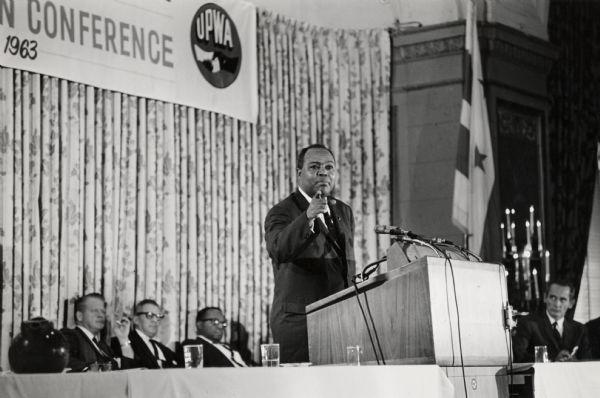 James L. Farmer, Jr. of CORE, speaking at a national conference of the United Packinghouse Workers of America. James Leonard Farmer, Jr. was a civil rights activist and leader of the American Civil Rights Movement. He co-founded the Committee of Racial Equality in 1942, which later became the Congress of Racial Equality (CORE). He was also the initiator and organizer of the 1961 Freedom Ride, which eventually led to the desegregation of inter-state transportation in the United States.