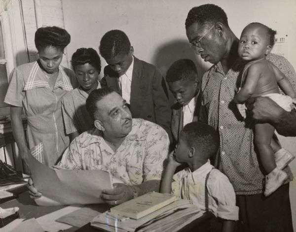 Russell Lasley, an African-american leader of the United Packinghouse Workers union and later the Amalgamated Meatcutters and Butcher Workers union, meeting with Lester Heard, a union member from Tennessee. That state was then attempting to extradite the man from Illinois, as he was wanted for an automobile accident involving a white woman. Heard feared mob violence if he returned. Here Lasley is seen attempting to intervene with Governor Adlai Stevenson in order to help Heard.