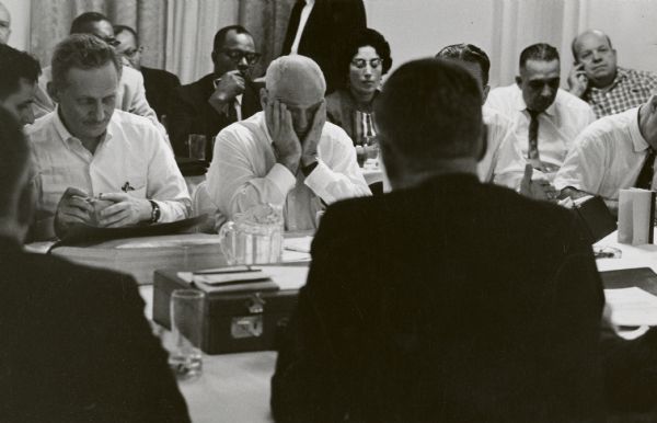 Ralph Helstein, president of the United Packinghouse Workers of America, with head in hands, exhibits obvious fatigue and frustration during the 1961 Armour contract negotiations. Fellow negotiater Jesse Prosten is on the left.