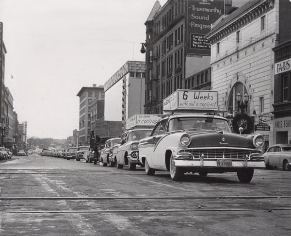 As part of a statewide boycott of Wilson products, delegates to the State Federation of Labor in Cedar Rapids participate in an automobile parade. One car-top sign reads: "Six weeks without a Contract."