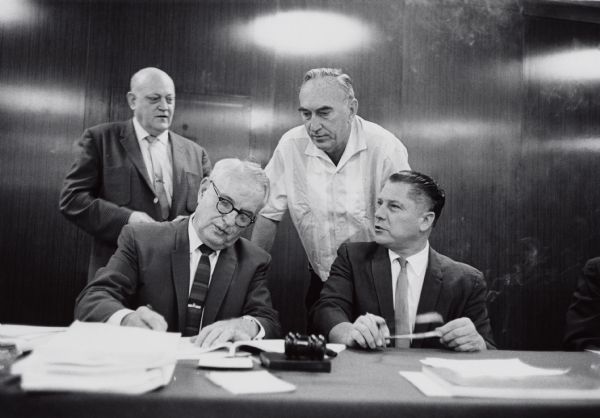 Frank Gorman of the Amalgamated Meatcutters union, and James Hoffa of the Teamsters, signing an agreement to bargain cooperatively with the F.M. Stamper Co. (later Banquet Foods). Relations between the two internationals were not always amicable, as they frequently contested in local representation elections.