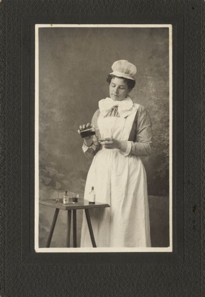 Studio portrait of nurse Ada Straub in her uniform. Ada Straub was a cousin of Mrs. Anton Nelson (the mother of Gaylord Nelson), who was also a nurse.