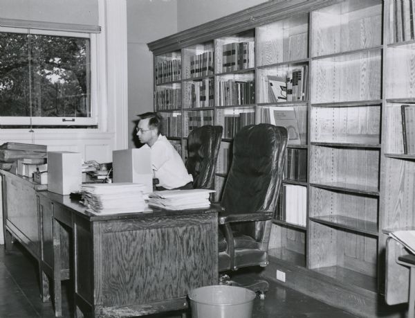 Maynard Brichford, Illinois State Archivist and noted authority on archives and record management issues, photographed earlier in his career in the archives offices of the Wisconsin Historical Society.