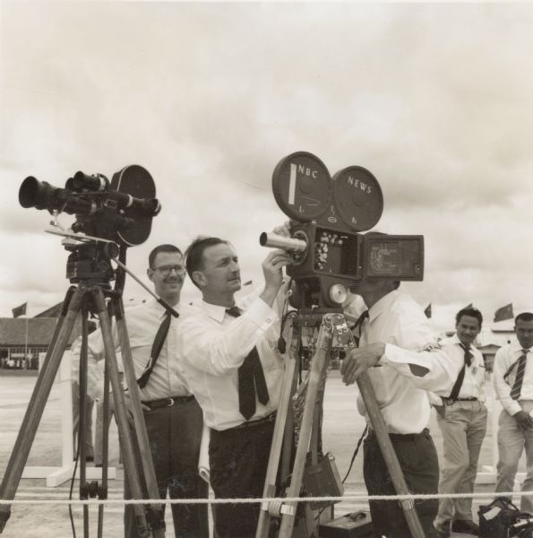 NBC television cameramen (Fred Rheinstein and Dexter Allen) preparing to film in Indonesia. They were covering a meeting between President Sukarno and Nikita Khruschev.