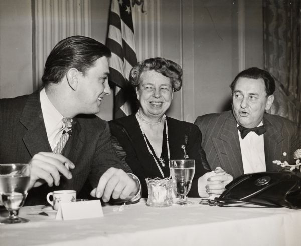 Eleanor Roosevelt and national co-chair Leon Henderson (right) at a dinner sponsored by the Union for Democratic Action (later Americans for Democratic Action) shortly after its establishment in 1947.  To Mrs. Roosevelt's right is her son, Franklin Roosevelt, Jr.
