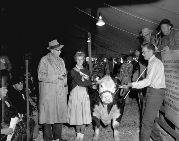 Alice in Dairyland 1960, Joan Engh, poses with a winner at a regional Junior Livestock Exposition. Joan went on to become Miss Wisconsin in 1962, and she was the first runner-up in the Miss America pageant.