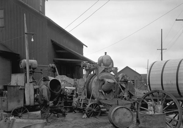 At the grasshopper bait mixing station at Fall Creek, two cement mixers were used to mix sawdust, a whey product, and sodium arsenite. So severe was the grasshopper outbreak of 1938 in northwestern Wisconsin that the station operated twenty-four hours a day, putting out 50-60 tons of bait.