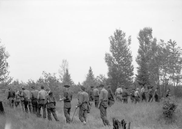 A crew of Civilian Conservation Corps (CCC) youth starting for the field where they were working on ribes eradication as part of the effort to defeat the white pine blister rust threat.